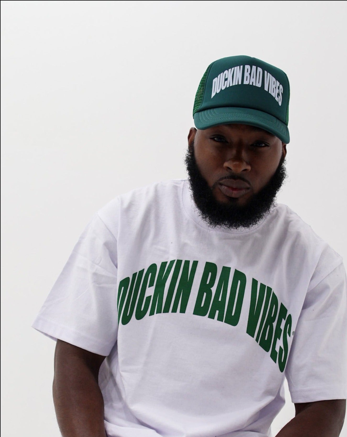 DUCKIN BAD VIBES ARCH TRUCKER HAT